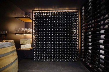 It's one thing to have a wine cellar and it's another to have Darren and Dea's creation. The winning room with its filled wine racks and shelves, barrel and bluestone honed floor tiles combined with the clever use of lighting just feels authentic.